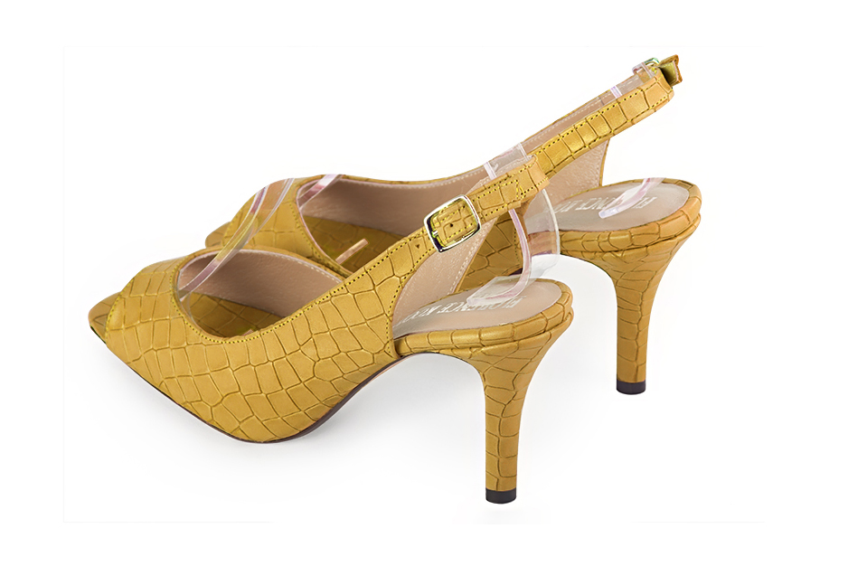 Women's mustard yellow open-toe dress pumps with back strap. Round toe. High slim heel - Rear view